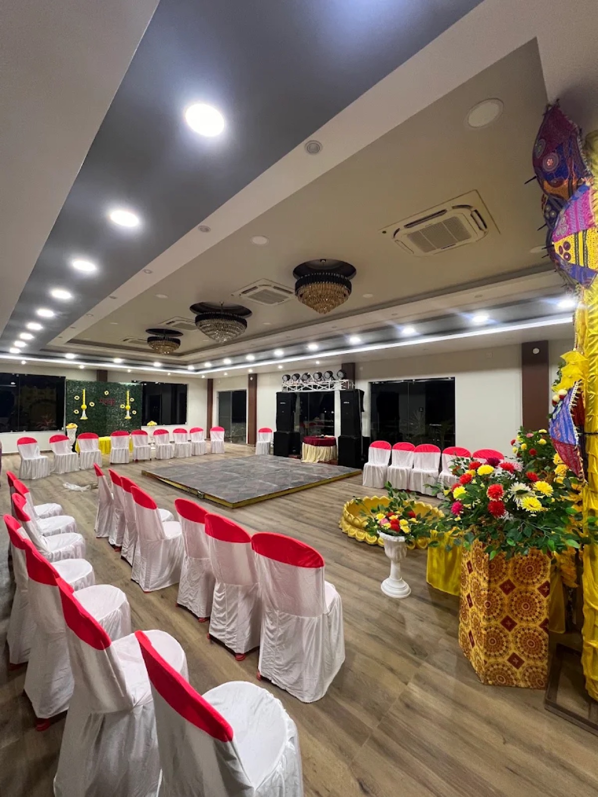 Function hall with decorated stage and chair seating at Shri Nath Palace, Deoghar