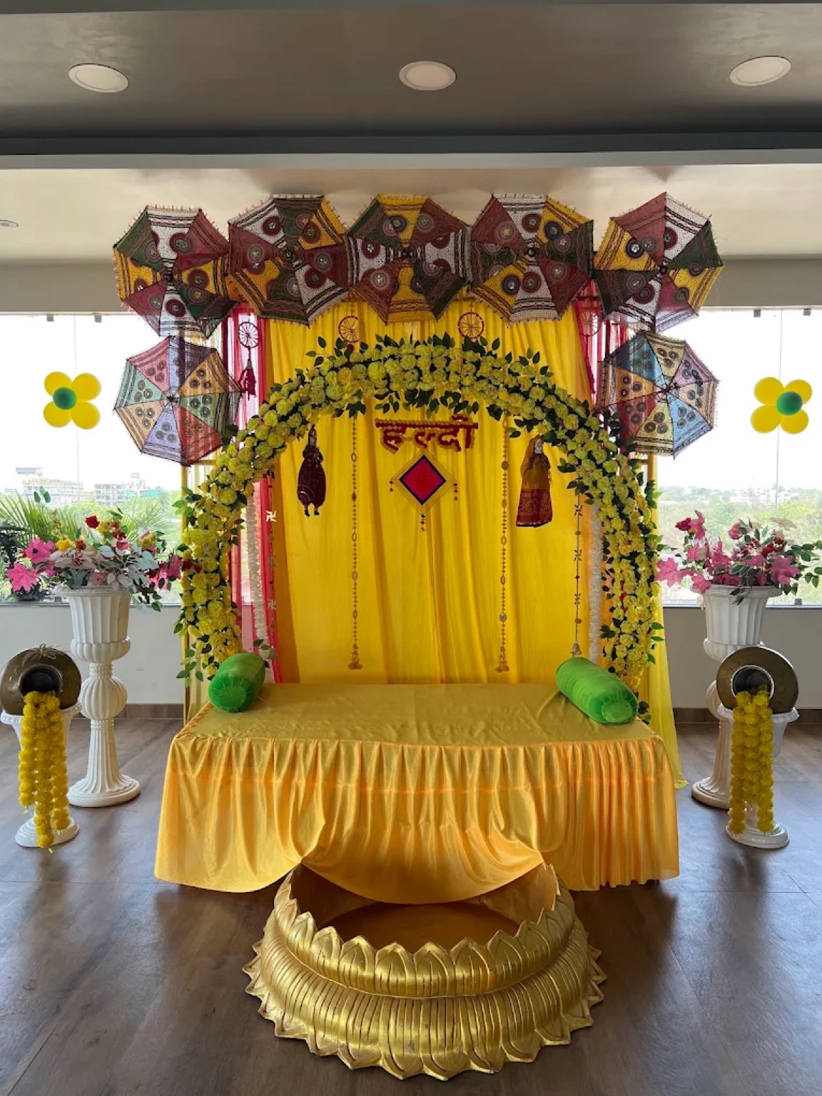 Haldi function backdrop with umbrellas and flowers at Shri Nath Palace, Deoghar