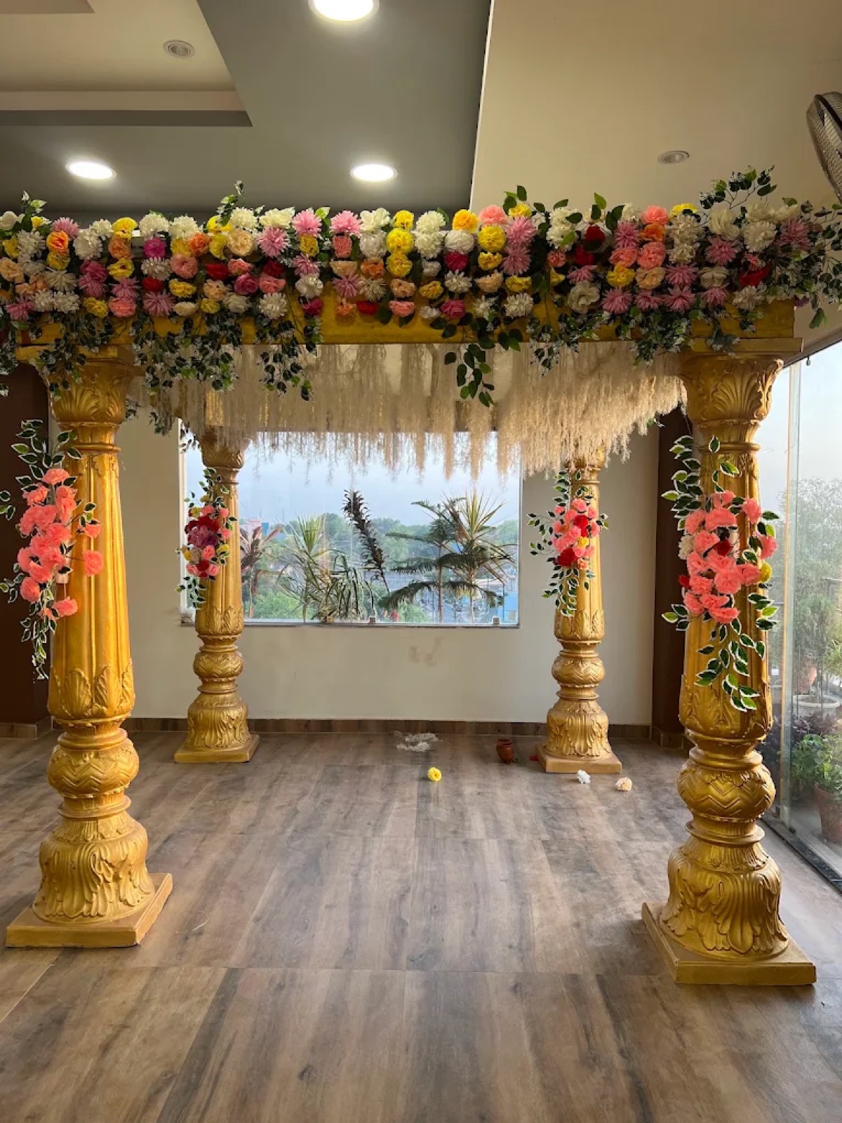 Golden pillar mandap with floral decoration at Shri Nath Palace, Deoghar